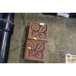 Two terracotta flower decorated bricks