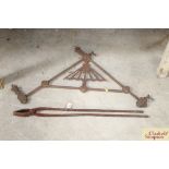 A pair of iron foundry tongs and a decorative iro