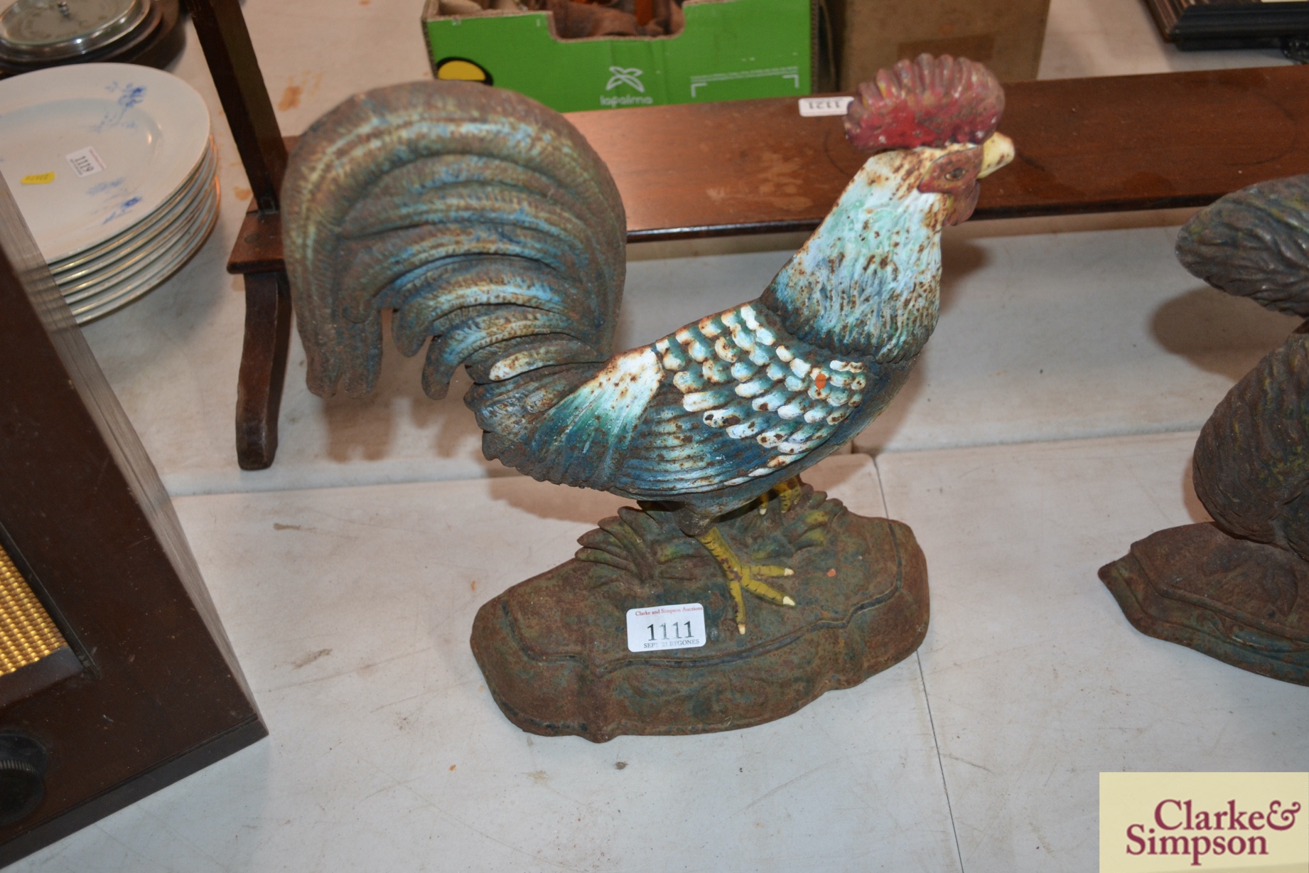 A cast iron door stop in the form of a cockerel