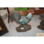 A cast iron door stop in the form of a cockerel