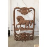 A Victorian style cast iron horse decorated stable windo