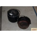 A black enamel cooking pot and lid with swing hand