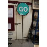 A vintage "Stop and Go" sign