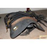 A heavy horse brass mounted bridle and saddle