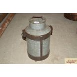 An old milk churn with swing handle