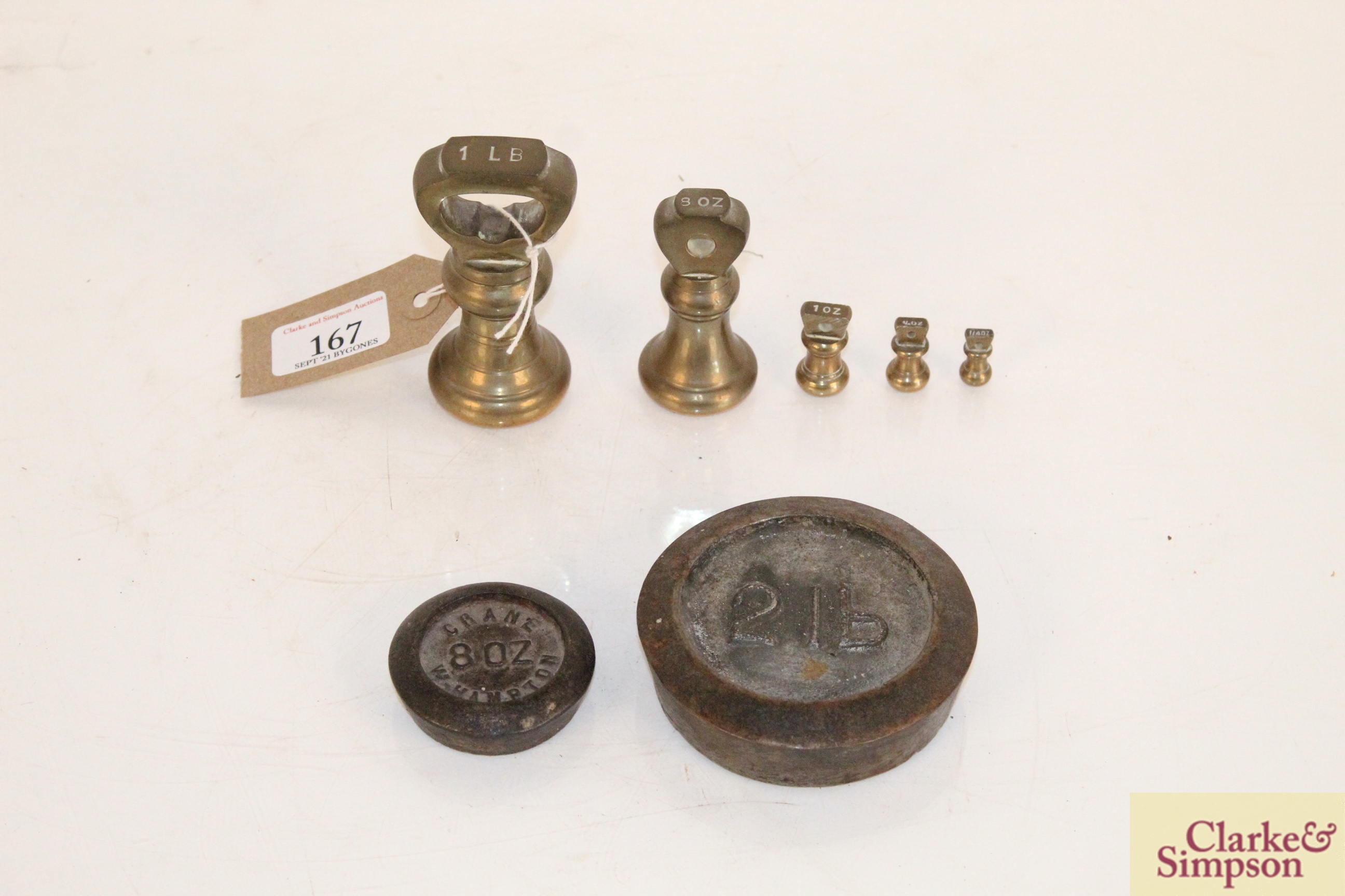 A set of brass graduated weights from 1lb to ¼oz,