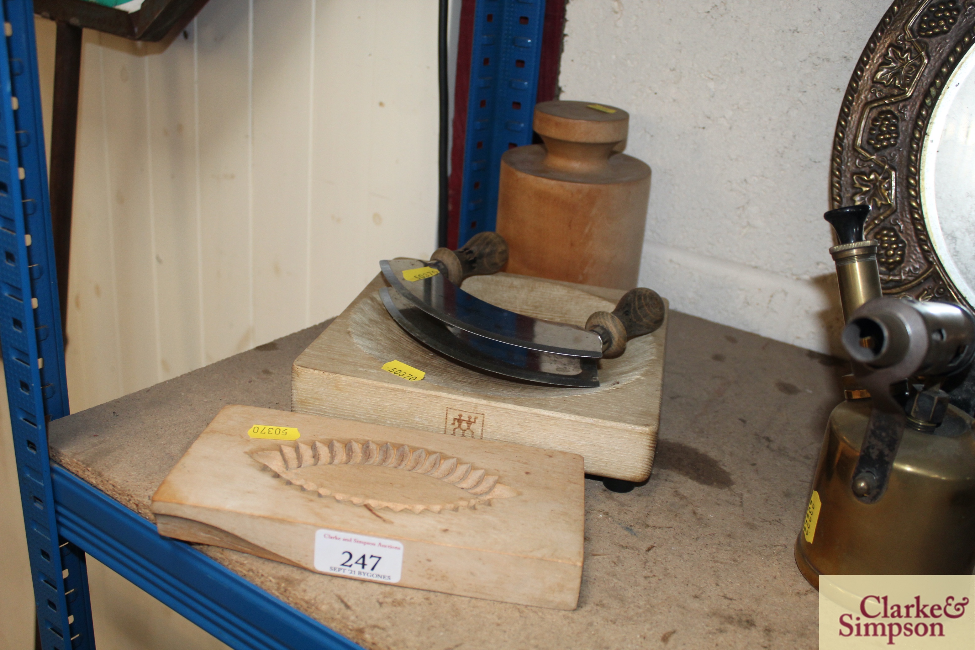 A pine kitchen mould, a pine chopping board, a herb chopper etc.