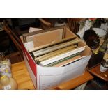 A box of various pictures prints and frames