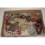 A box of rosary beads and religious pendants