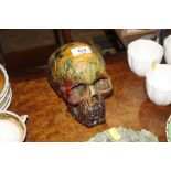 An amber coloured skull ornament