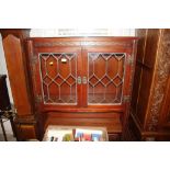 An Old Charm oak and leaded glazed cabinet