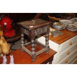 An antique oak stool raised on bobbin supports