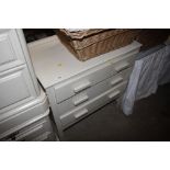 A white painted chest fitted three drawers