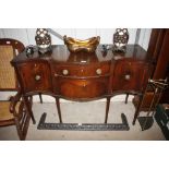 An antique mahogany serpentine fronted sideboard