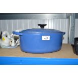 A Le Creuset blue cooking pot with lid