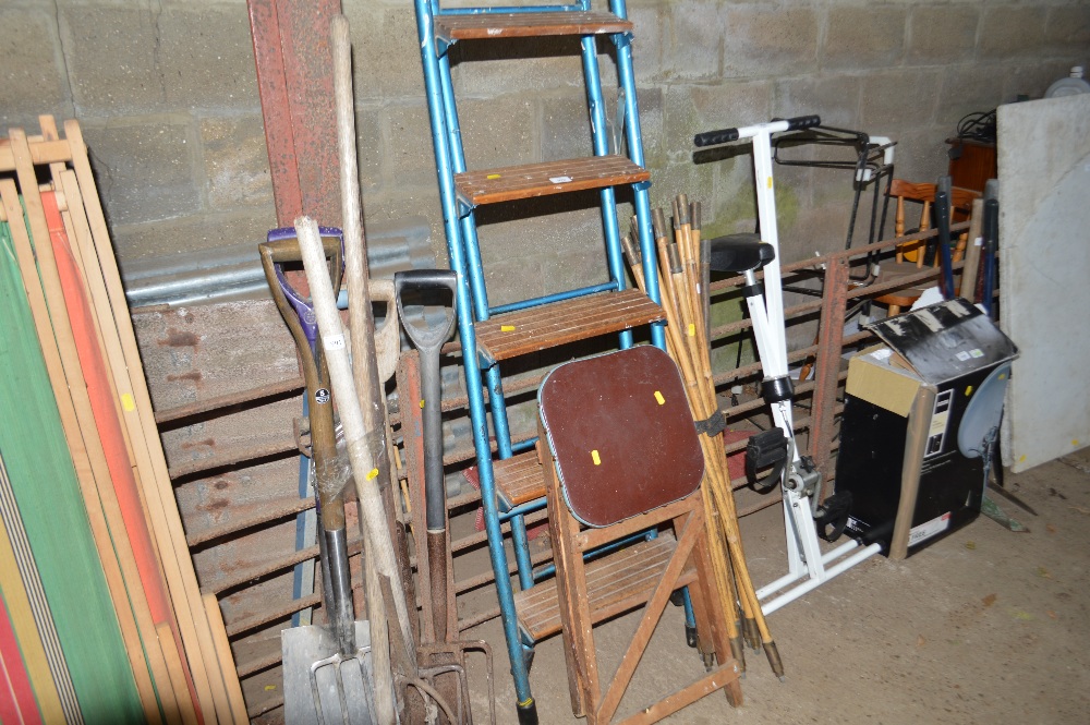 A tall set of metal framed steps and a small pair