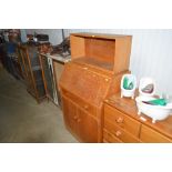 A modern oak bureau and oak book shelf above