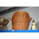 A wicker linen basket with lid