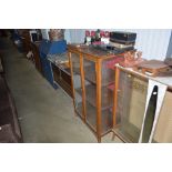 An oak and glazed display cabinet