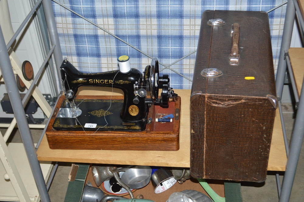 A "Singer" hand sewing machine with case