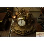 A French gilt metal mantel clock with figural deco