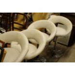 Four leather and chrome swivel stools