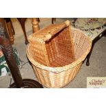 A wicker log basket on wheels and a wicker bread b