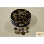 A tin of mainly military buttons and badges