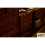 A walnut and herringbone banded bedside chest fitt