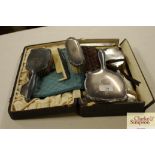 A silver backed dressing table set and a plated si