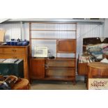 A teak shelving unit with glass sliding doors