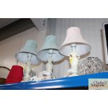 Three table lamps and a quantity of shades, and a