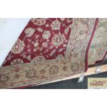 An approx 6'5" x 4'5" red floral patterned rug