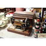 A 'Singer' hand sewing machine in fitted case
