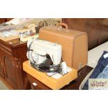 A Singer Electric sewing machine in fitted carry c