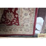 An approx 7'7" x 5'7" red floral patterned rug