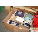 A box containing various cigarette cards, puzzles,