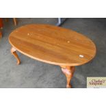 An oak oval topped coffee table