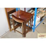 A nest of three mahogany occasional tables