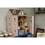 A doll's house and two tubs of various furniture