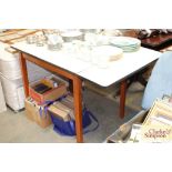 A 1950's melamine top table with one folding leaf