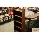 An oak open fronted bookcase of narrow proportion