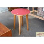 A circular topped kitchen table
