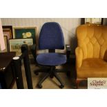 A blue upholstered swivel office chair