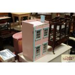 A small doll's house lacking contents