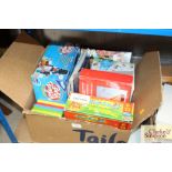 A box of children's games and Tractor Ted DVDs
