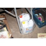 Two containers of steam cleaner; detergent and car