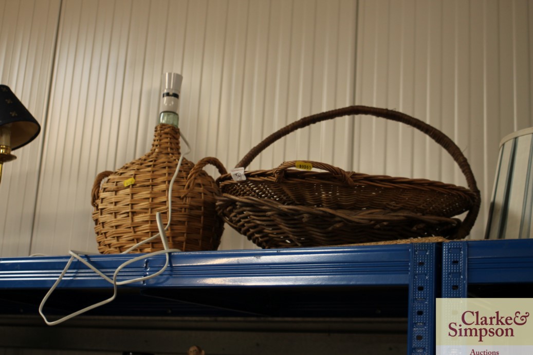 Two wicker baskets and a wicker covered table lamp