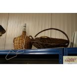 Two wicker baskets and a wicker covered table lamp