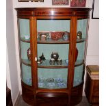 An Edwardian inlaid mahogany bow fronted display cabinet, the interior shelves enclosed by curved